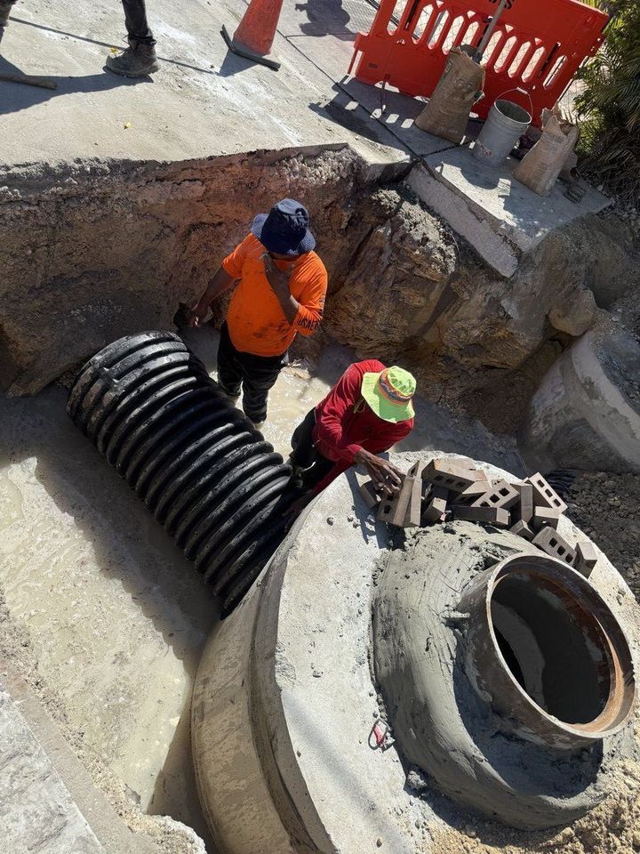 Crew connecting corrugated pipe to a precast structure